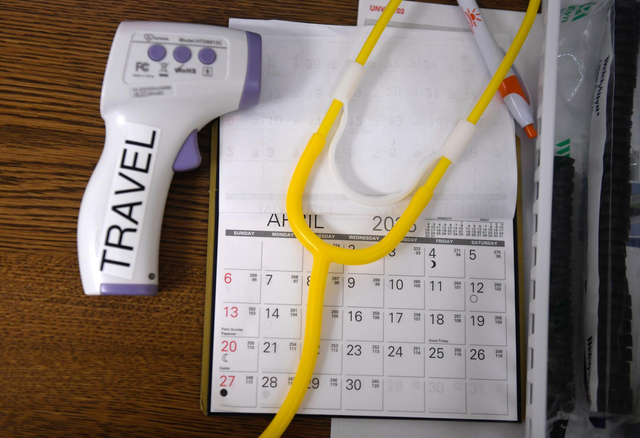 A no-contact thermometer, stethoscope and calendar