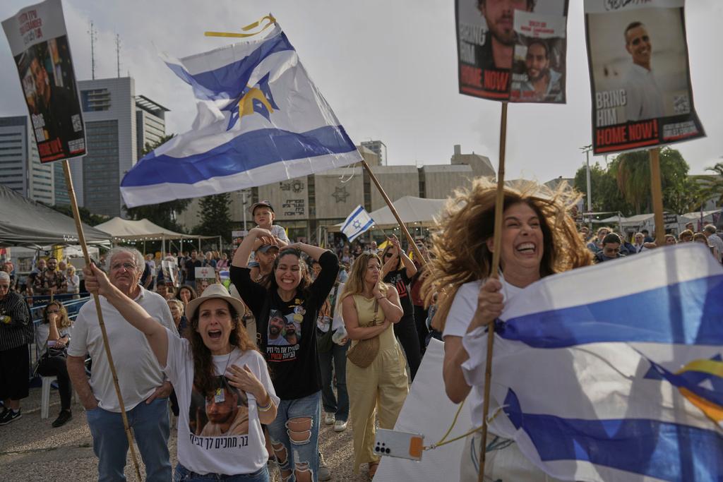 In Tel Aviv, people react as they gather to watch a live broadcast of Israeli-American soldier Edan Alexander to be released from Hamas captivity in Gaza