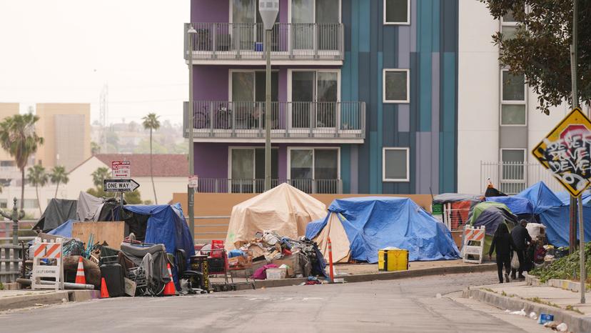 Tents are set up along a freeway in a homeless encampment in Los Angeles