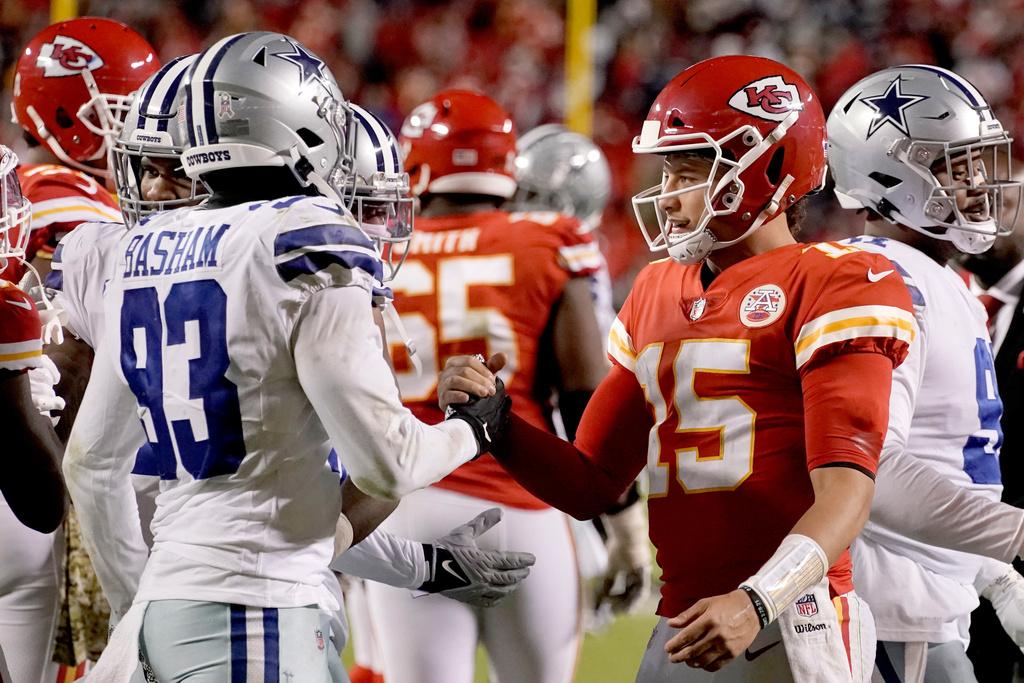 Kansas City Chiefs quarterback Patrick Mahomes (15) and Dallas Cowboys defensive end Tarell Basham (93) greet each other after an NFL football game