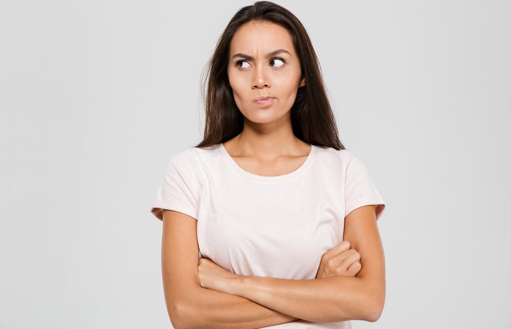 Woman looking mad and crossing her arms