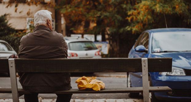 Old man sitting on park bench