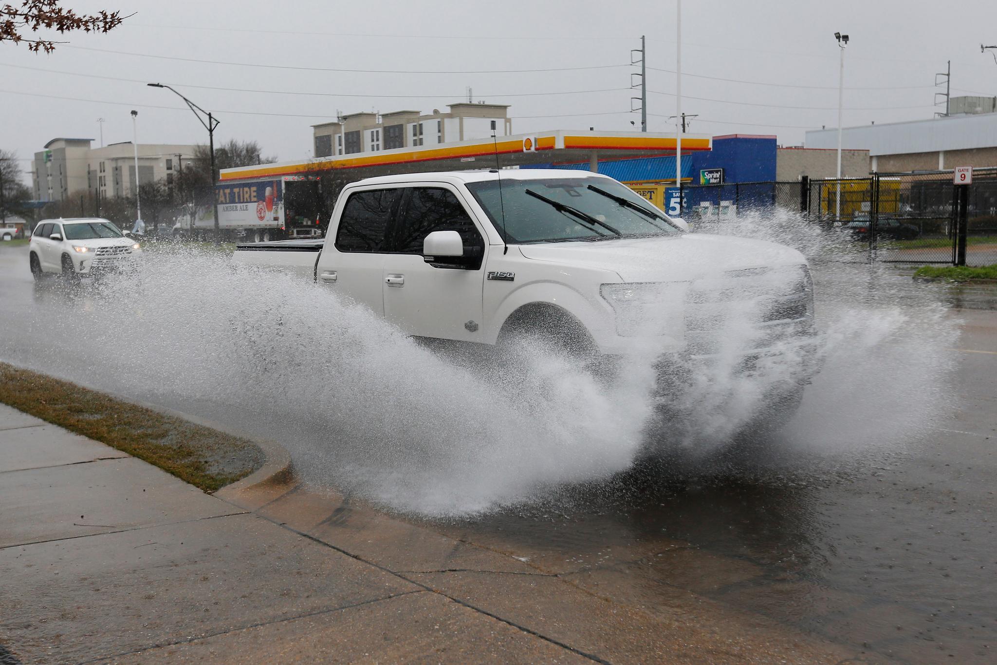truck running through puddle