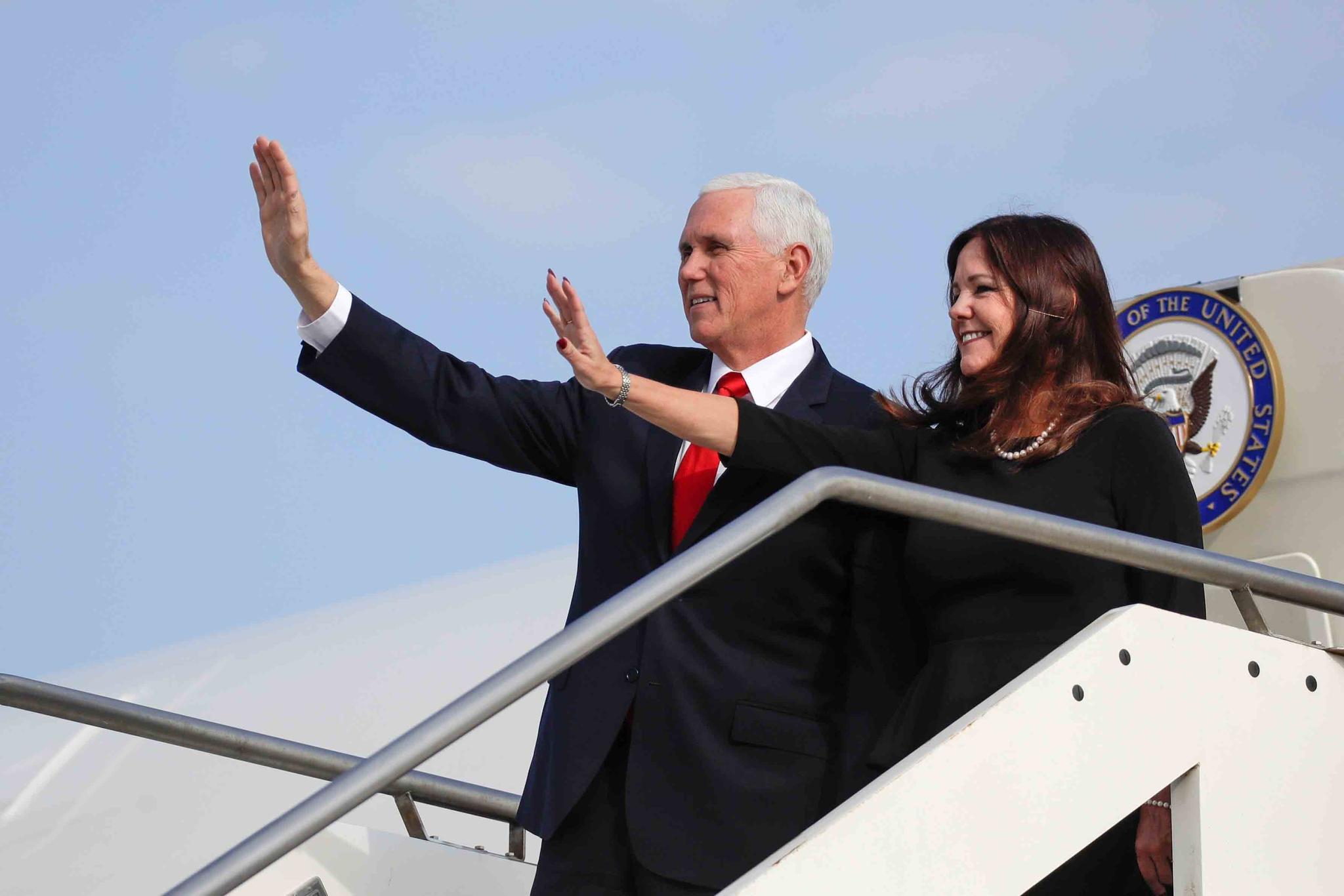 Vice President Mike Pence and his wife Karen, right, wave as they disembark from Air Force Two upon their arrival at Rome's Ciampino airport