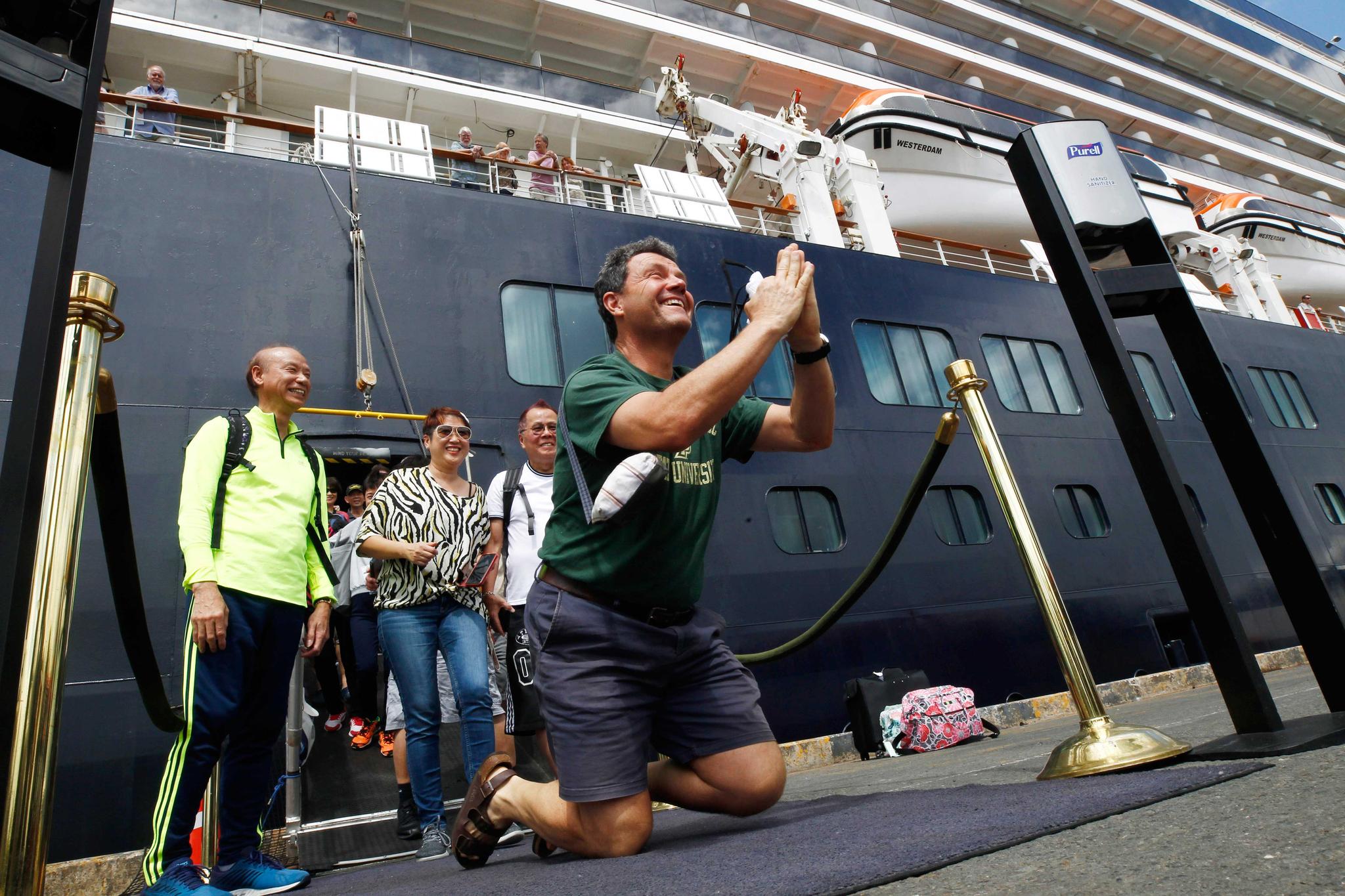 Man reacts after he disembarked from ship