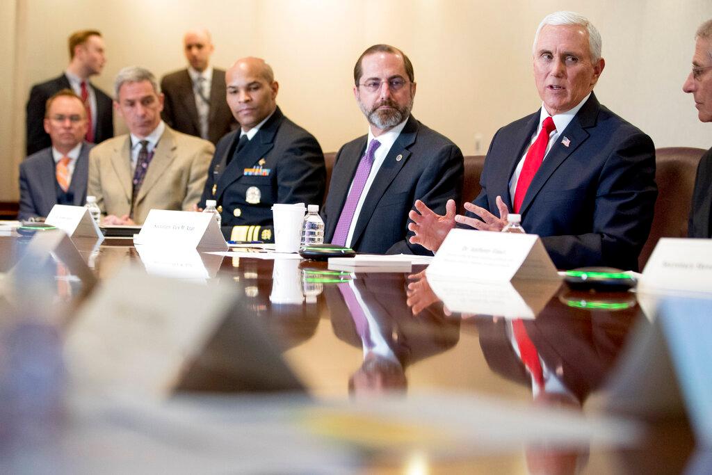 Vice President Mike Pence, third from left, accompanied by Surgeon General Jerome Adams, left, Health and Human Services Secretary Alex Azar, and others, speaks during a coronavirus task force meeting at the Department of Health and Human Services