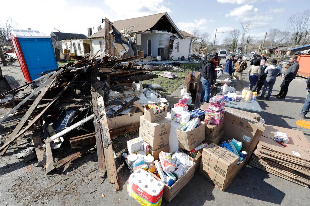 Ron Thompson Jr. walks by a pile of debris on his family's property Friday, March 6, 2020, in Nashville, Tenn. Residents and businesses face a huge cleanup effort after tornadoes hit the state Tuesday.