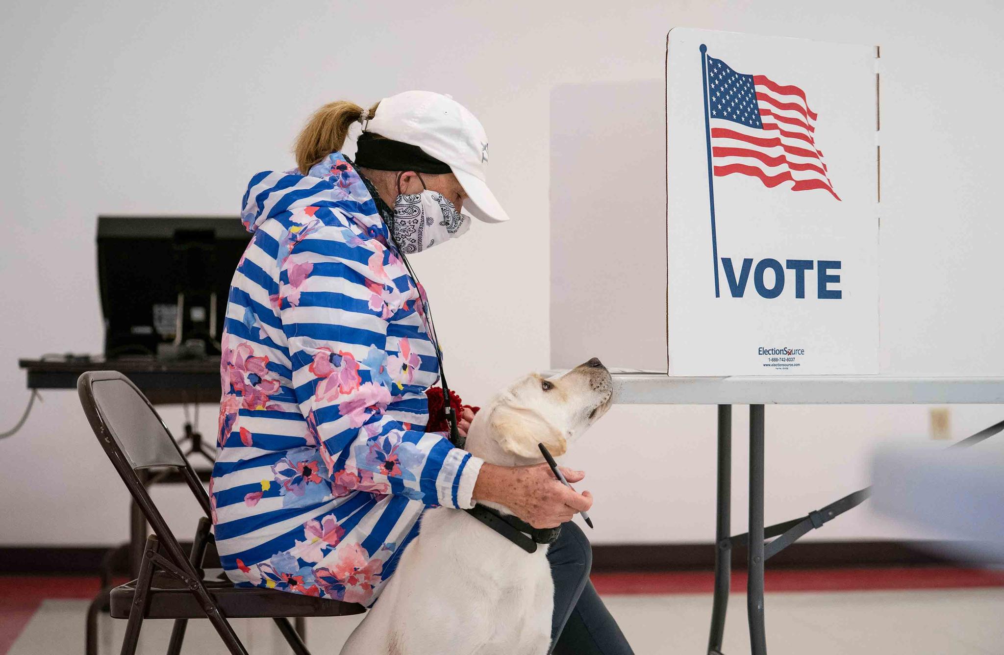 Catherine Anderson sits with her dog, Ivy, as she votes in the Wisconsin Primary at the Billings Park Civic Center in Superior, Minnesota