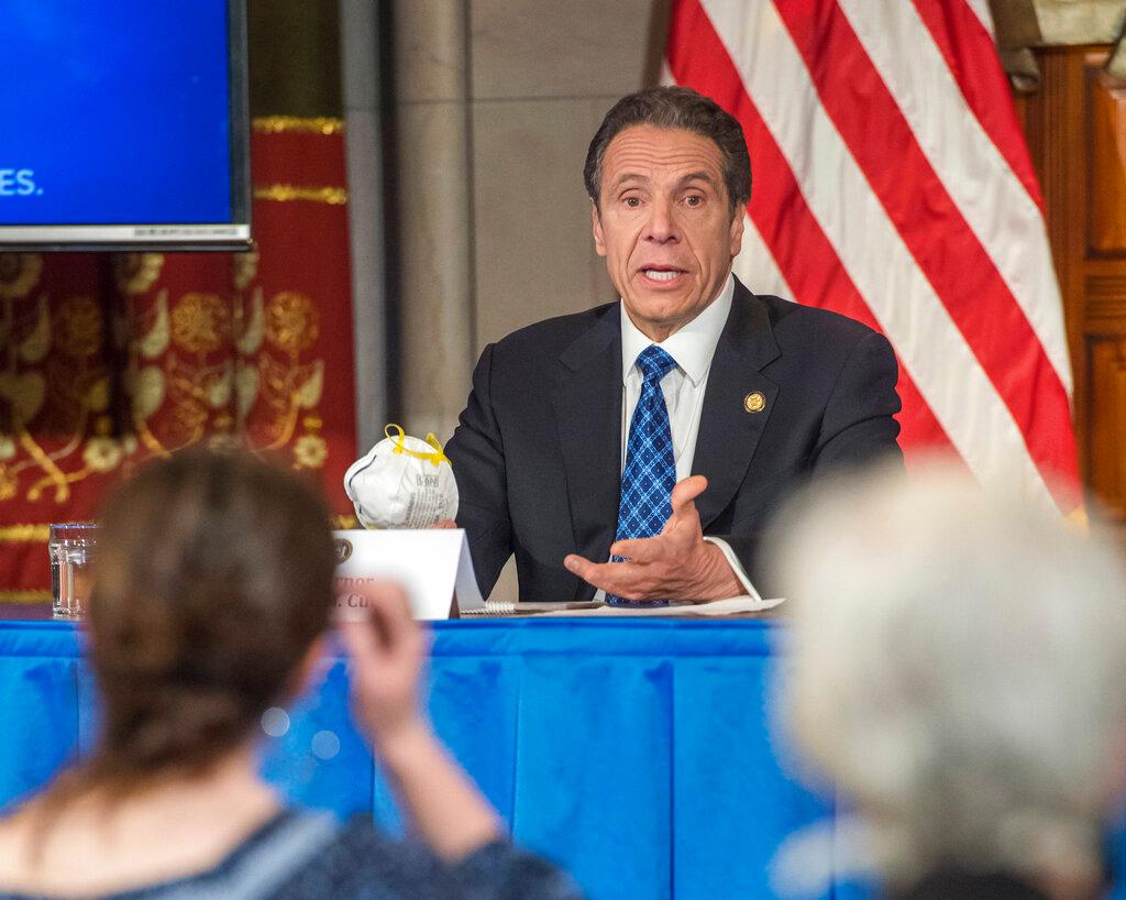 Gov. Cuomo addresses the media while holding an n95 mask during his daily press briefing on COVID-19, Coronavirus, at the State Capitol in Albany, N.Y. The mask was sent to the governor by a retired farmer from Kansas whose wife only has one lung.