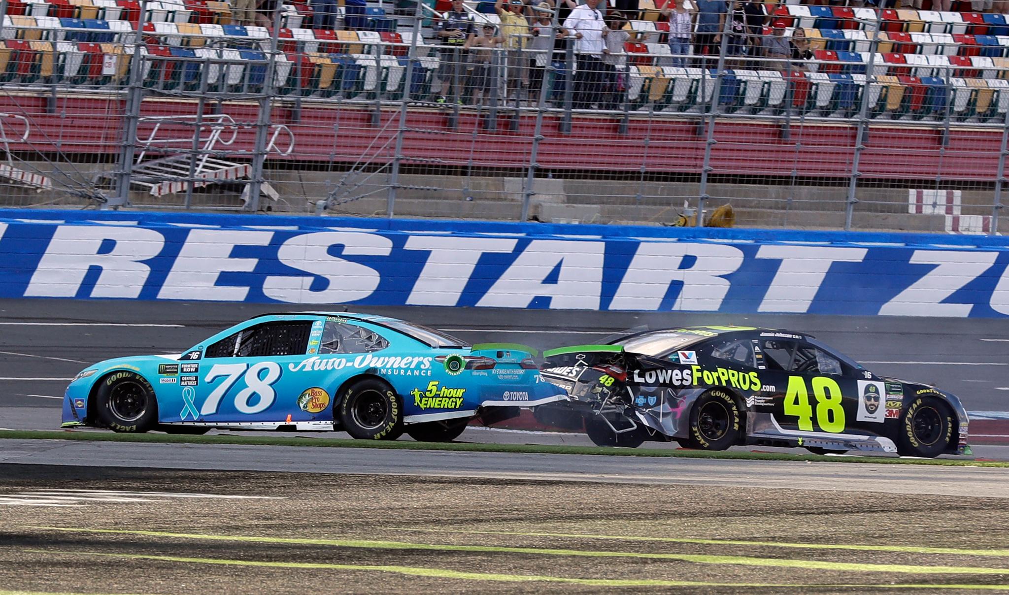 Martin Truex Jr., (78) and Jimmie Johnson (48) crash on the final lap during the NASCAR Cup series auto race at Charlotte Motor Speedway in Concord, N.C.
