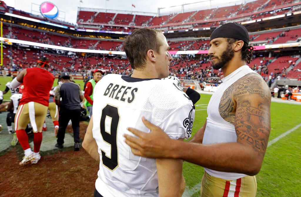 Nov. 6, 2016, file photo, San Francisco 49ers quarterback Colin Kaepernick, right, is greeted by New Orleans Saints quarterback Drew Brees at the end of an NFL football game in Santa Clara, Calif