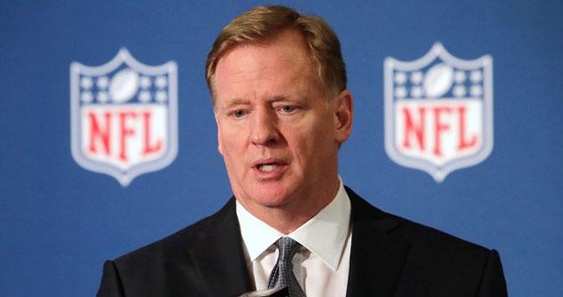 NFL Commissioner Roger Goddell in front of two NFL symbols