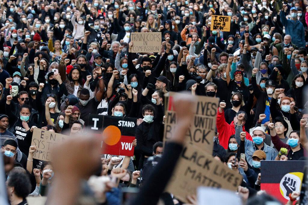 Protesters gather in Sydney, Saturday, June 6, 2020, to support the cause of U.S. protests over the death of George Floyd. Black Lives Matter protests across Australia proceeded mostly peacefully as thousands of demonstrators in state capitals honored the memory of Floyd and protested the deaths of indigenous Australians in custody.
