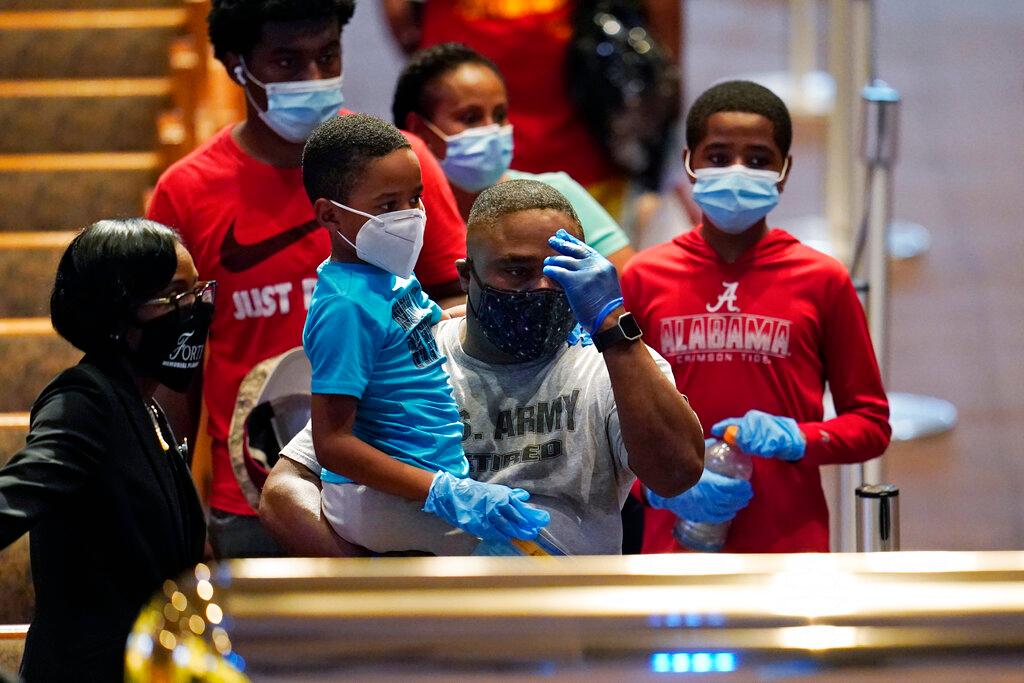 Mourners pass by the casket of George Floyd during a public visitation for Floyd at the Fountain of Praise church in Houston