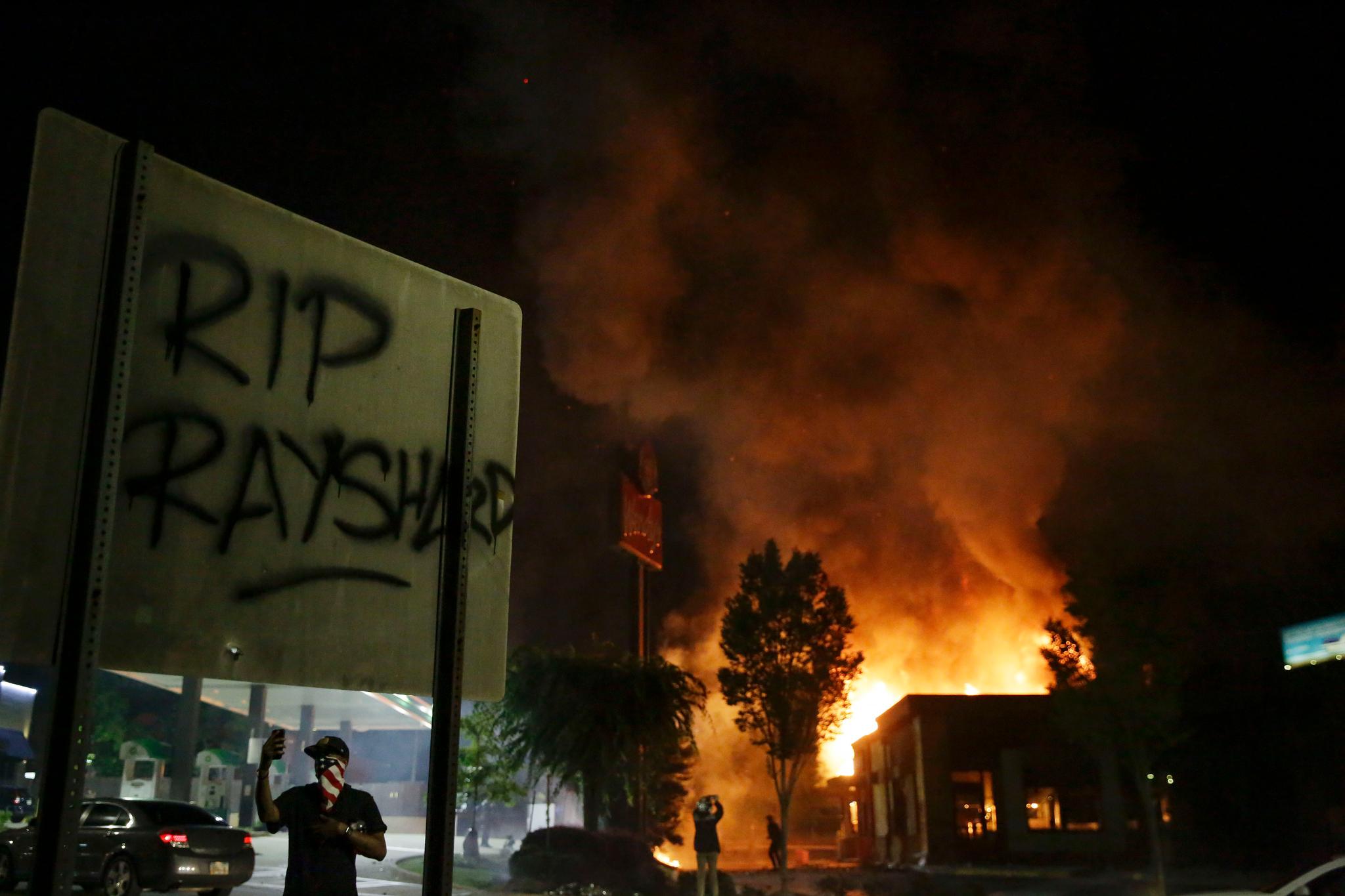 Flames engulf a Wendy's restaurant  where Rayshard Brooks was shot and killed by police Friday evening