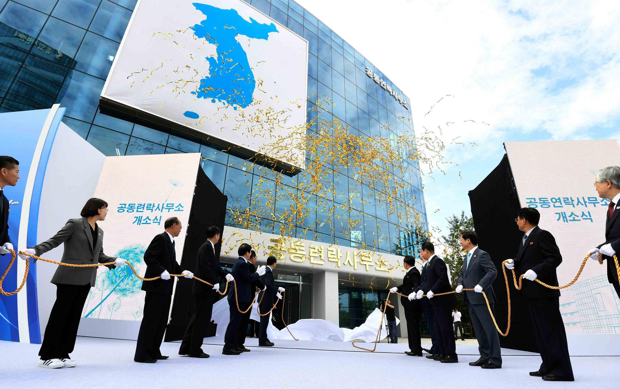 South Korea's Unification Minister Cho Myoung-gyon, center left, and Ri Son Gwon, chairman of the North's Committee for the Peaceful Reunification, center right, attend at an opening ceremony for two Koreas' first liaison office in Kaesong, North Korea.