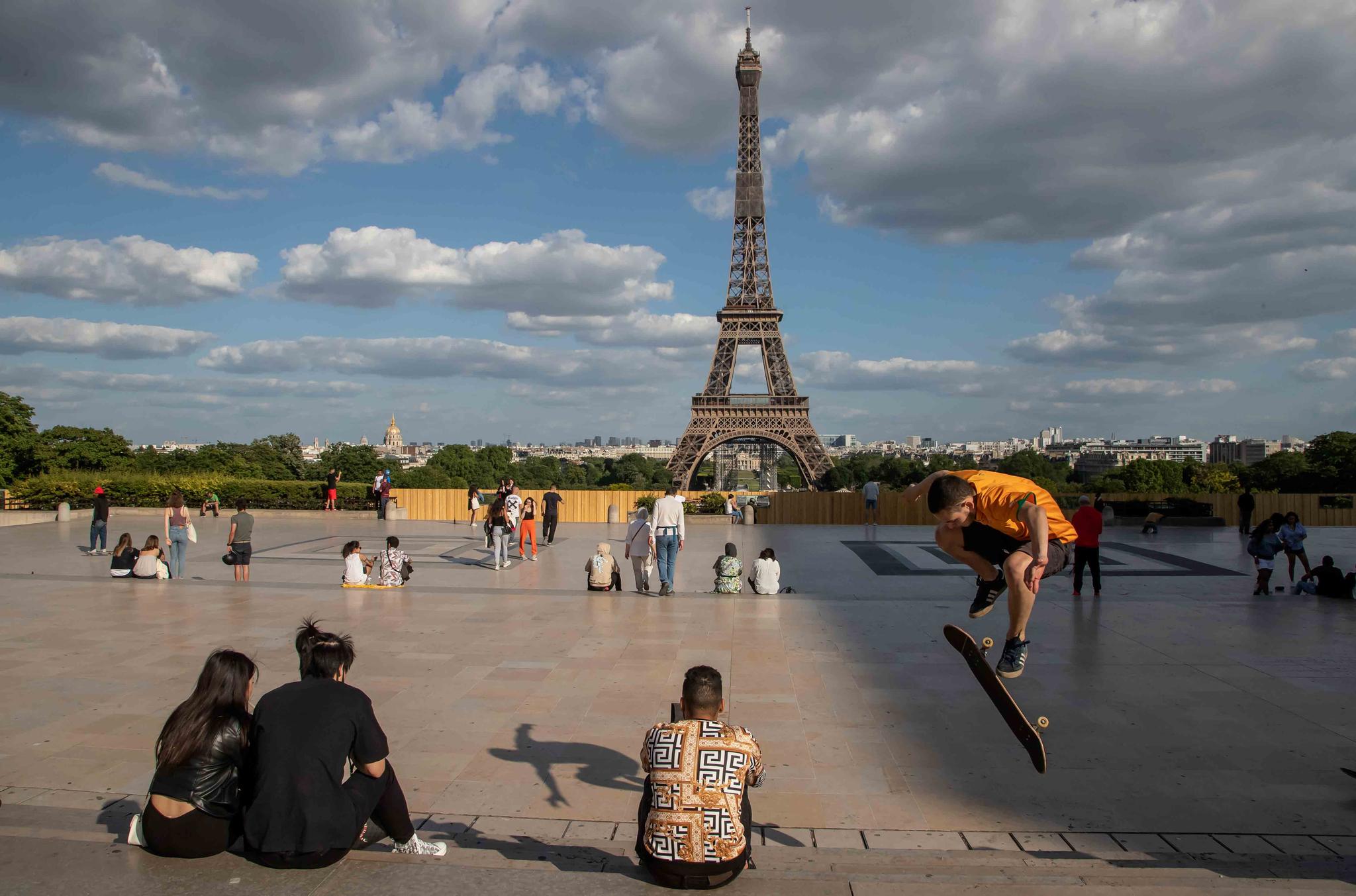 People stroll at Trocadero square near the Eiffel Tower in Paris