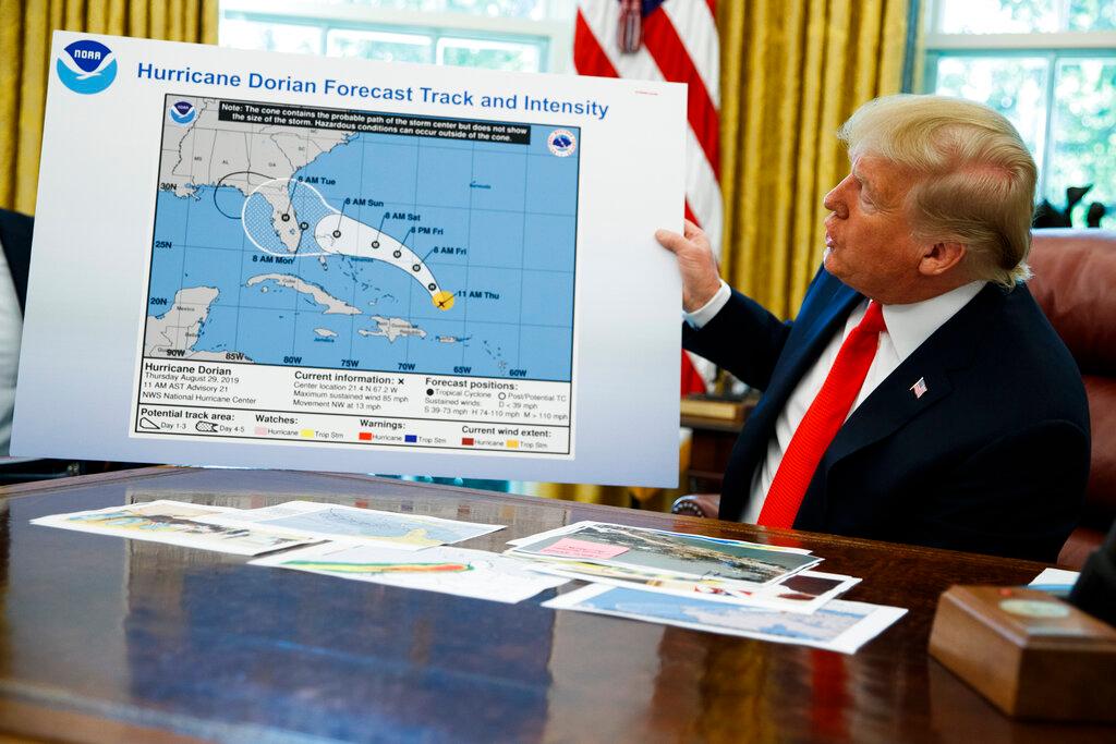President Trump Holding Weather Chart 