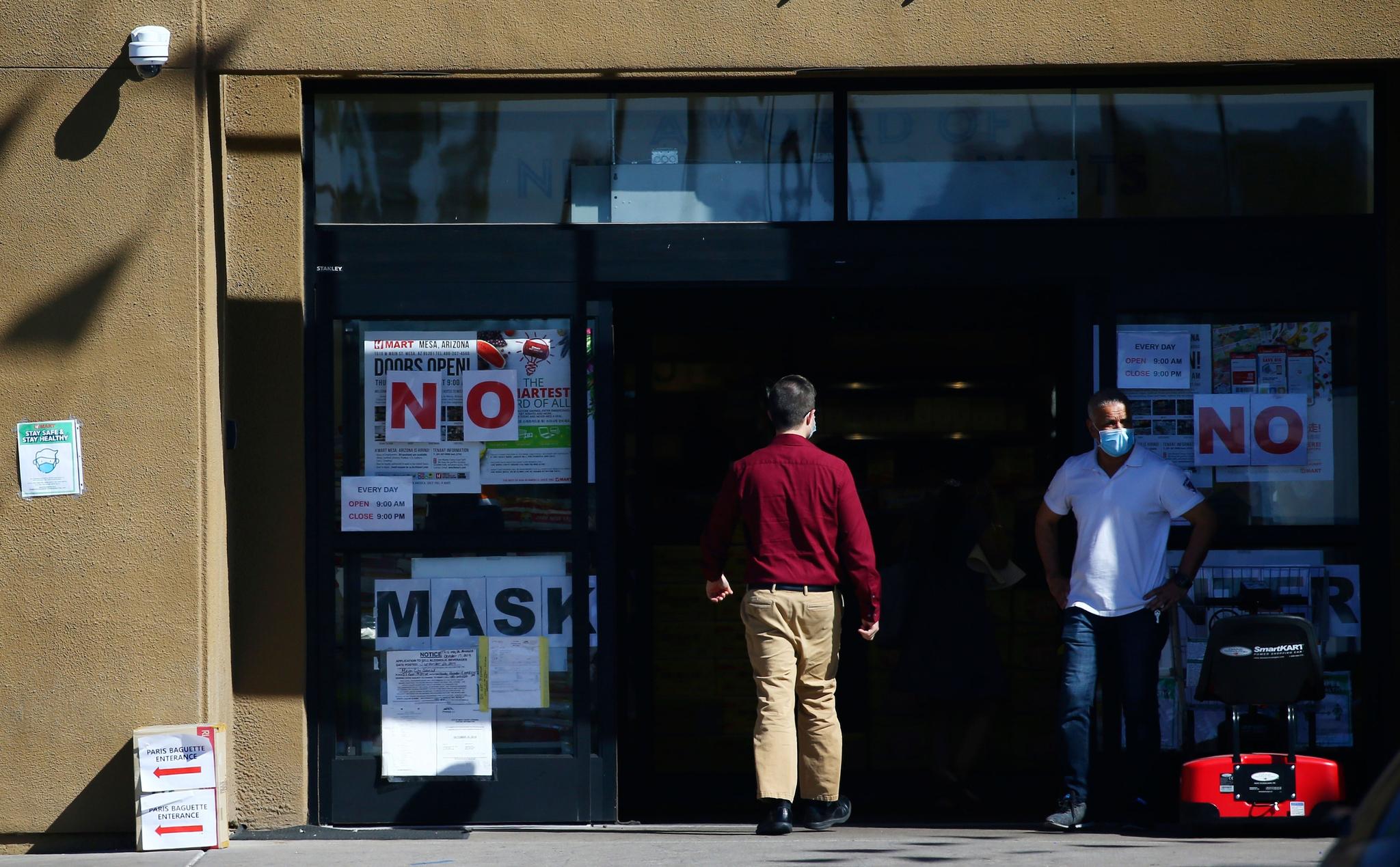 store posts several signs letting customers know that face masks are required