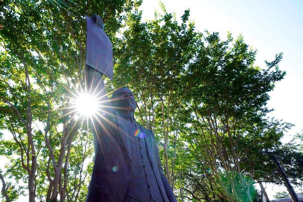 Galveston, TX statue depicting a man holding the state law that made Juneteenth a state holiday