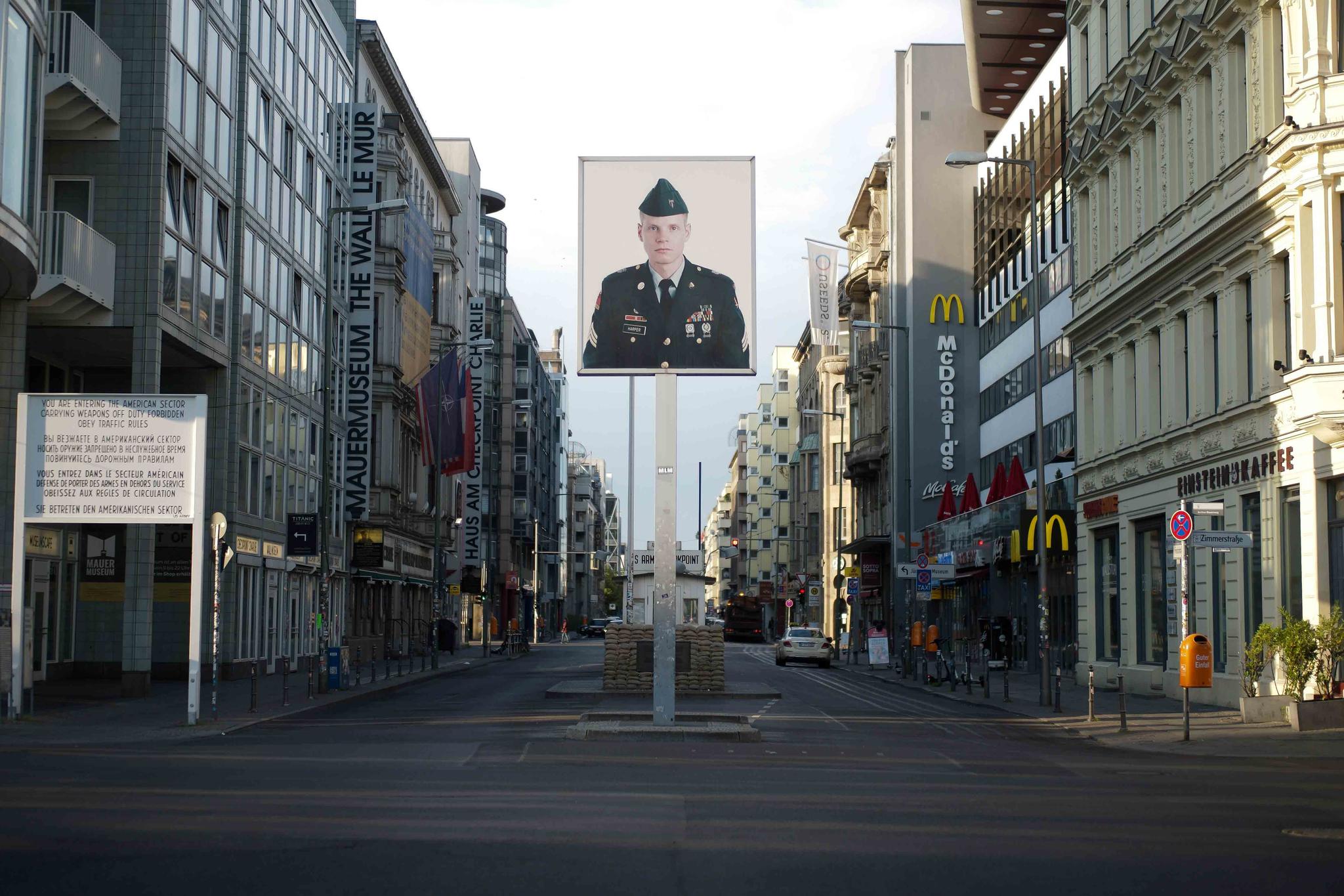 A picture of a former American soldier is displayed at the former U.S. army Checkpoint Charlie in Berlin, Germany