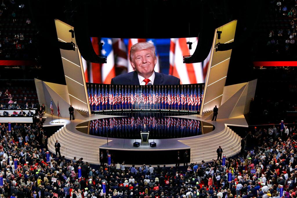 In this July 21, 2016, file photo Republican presidential candidate Donald Trump smiles as he addresses delegates during the final day session of the Republican National Convention in Cleveland. After months of insisting that the Republican National Convention go off as scheduled despite the coronavirus pandemic, Trump is slowly coming to accept that the event will not be the four-night informercial for his re-election that he had anticipated.