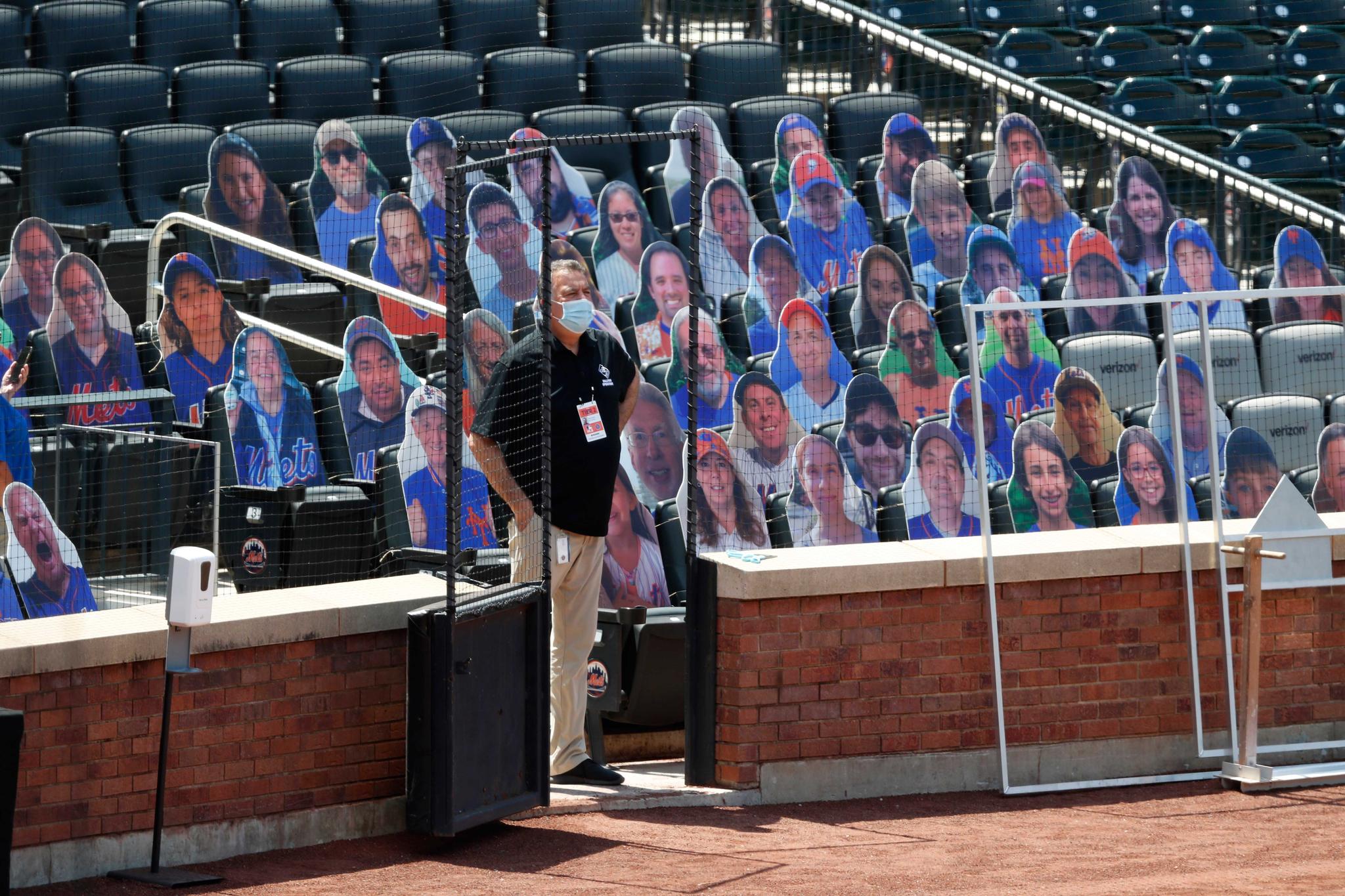 cardboard cutouts of fans in the stands during baseball practice