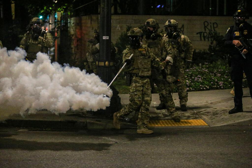 Police respond to protesters during a demonstration, Friday, July 17, 2020 in Portland, Ore. Militarized federal agents deployed by the president to Portland, fired tear gas against protesters again overnight as the city’s mayor demanded that the agents be removed and as the state’s attorney general vowed to seek a restraining order against them.