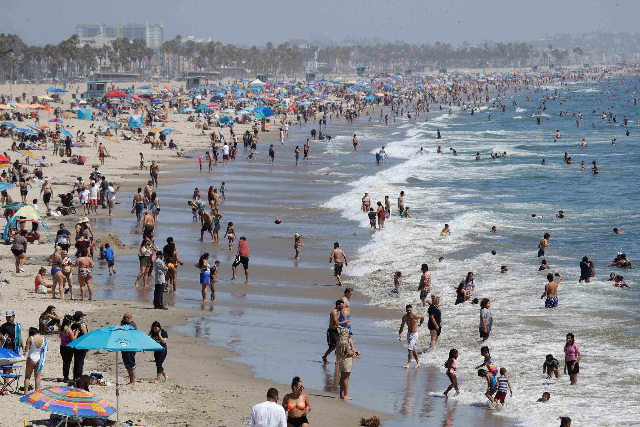 Visitors crowd the beach in Santa Monica, California