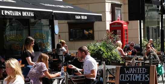 Sign outside restaurant reads: "Wanted Customers" in central London