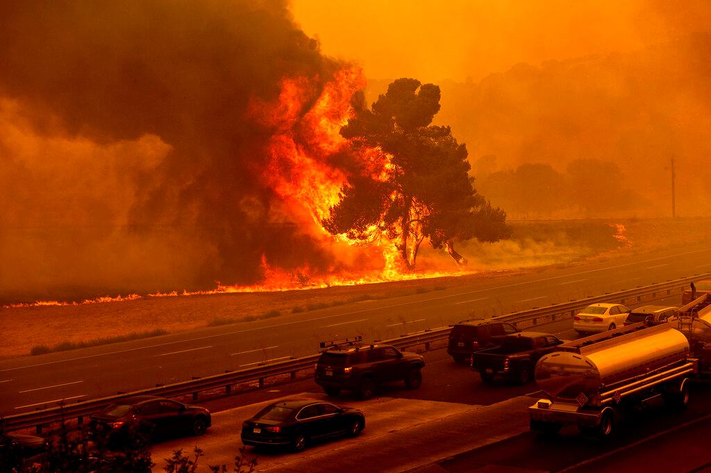 Flames from the LNU Lightning Complex fires jump Interstate 80 in Vacaville, Calif