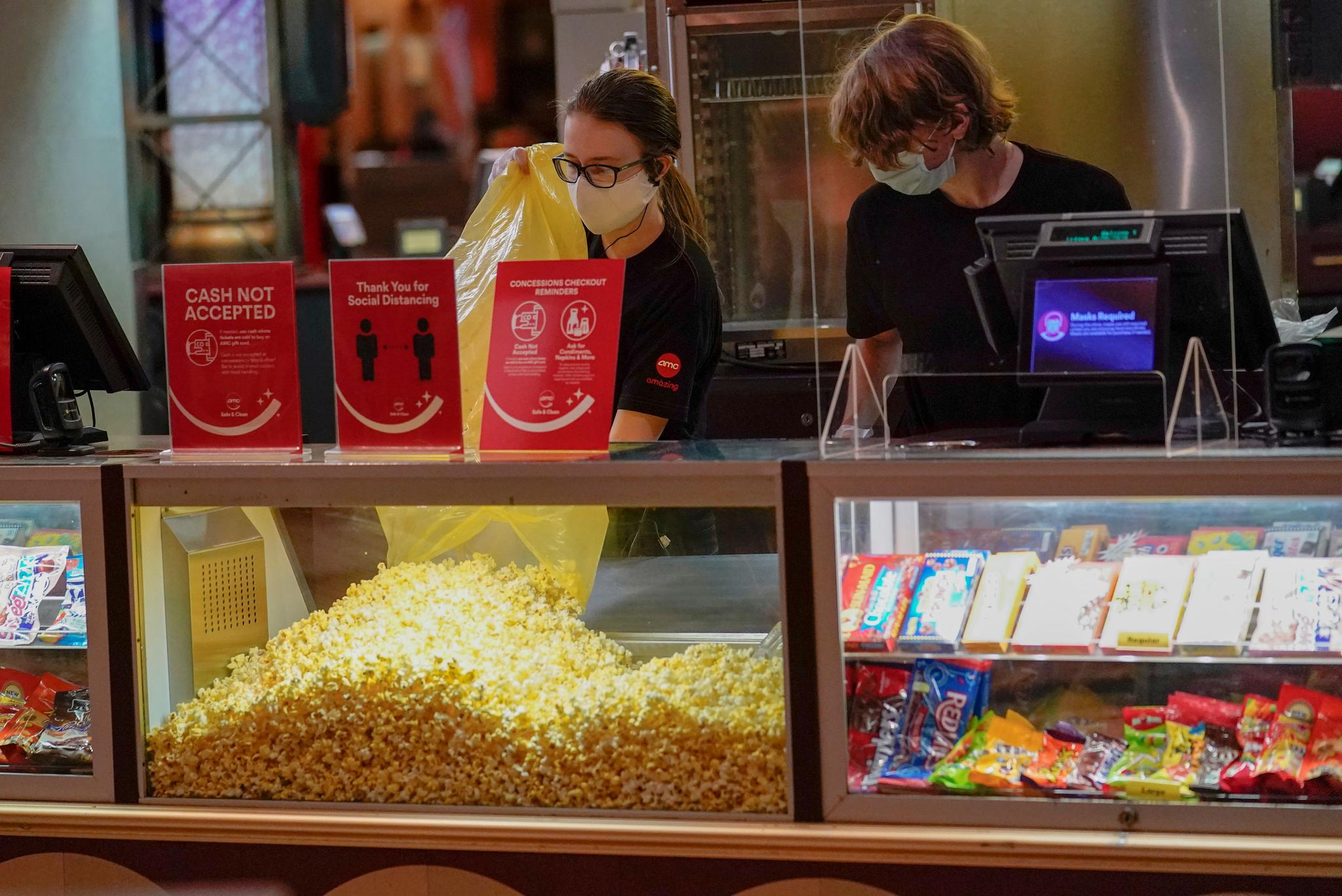 Concessions workers stock the bins with popcorn and other treats