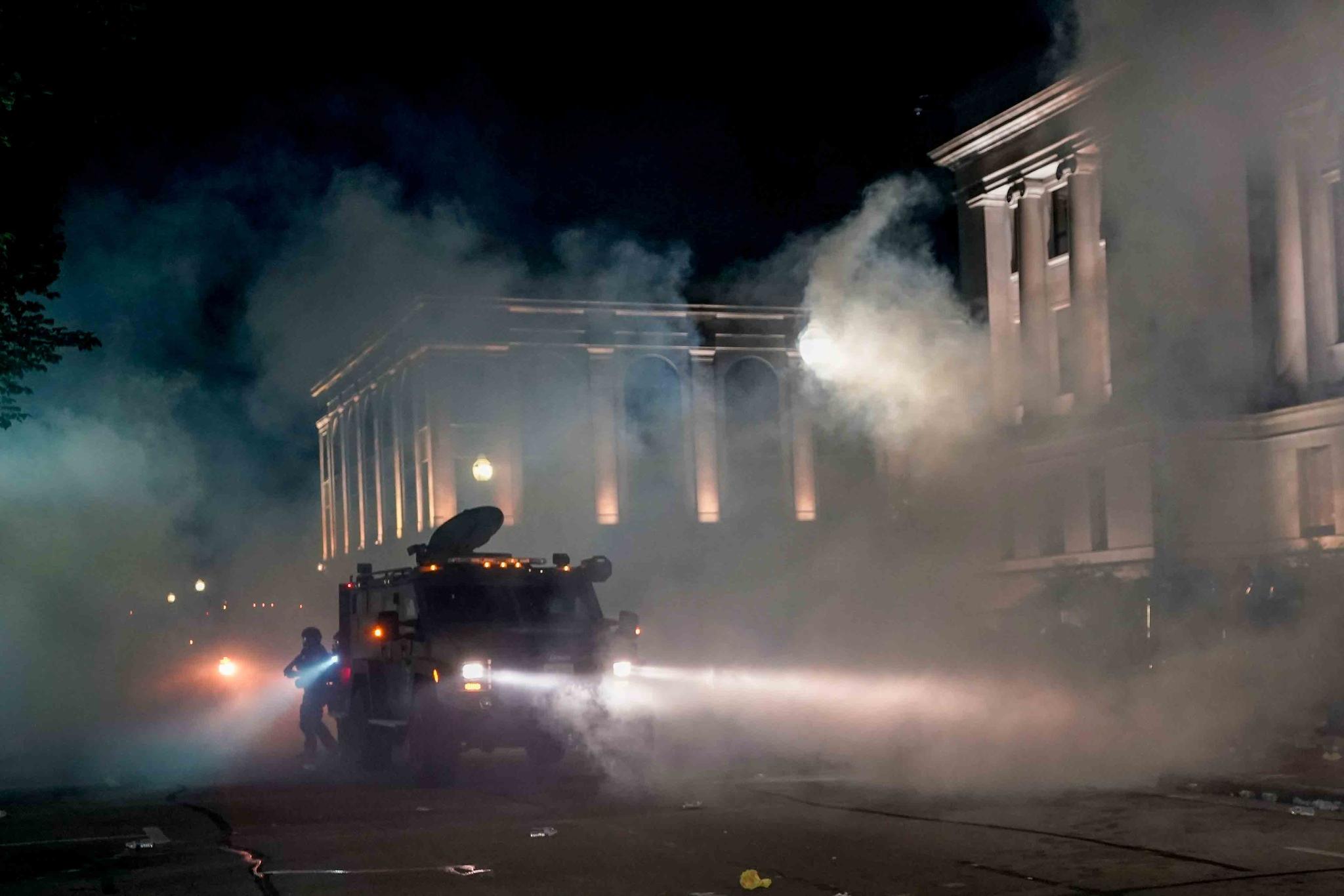 Police clash with protesters near the Kenosha County Courthouse, Monday, Aug. 24, 2020, in Kenosha, Wis.