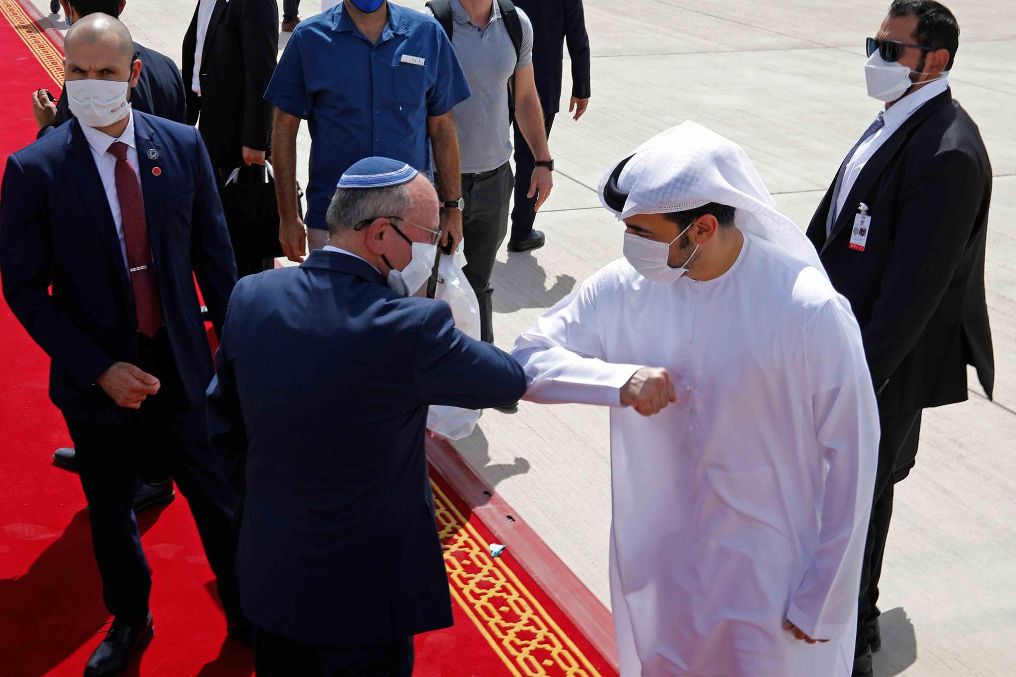 Israeli National Security Advisor Meir Ben-Shabbat, center left, elbow bumps with an Emirati official as he leaves Abu Dhabi, Arab Emirates, Tuesday, Sept. 1, 2020.