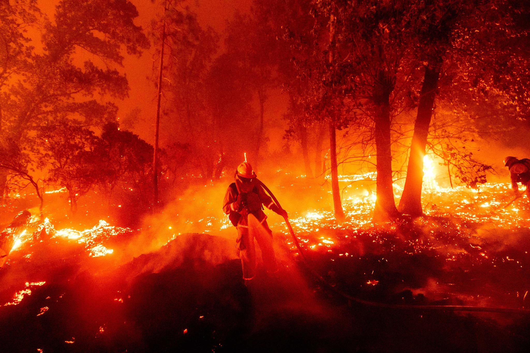 A firefighter battles a wildfire