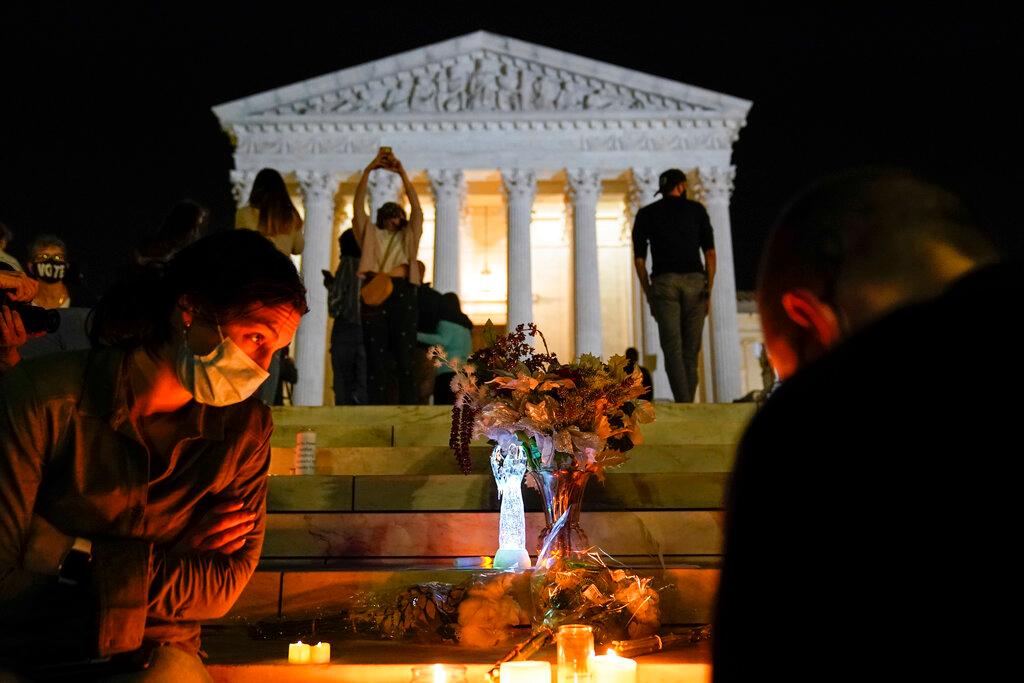People gather at the Supreme Court Friday, Sept. 18, 2020, in Washington, after the Supreme Court announced that Supreme Court Justice Ruth Bader Ginsburg died of metastatic pancreatic cancer at age 87.