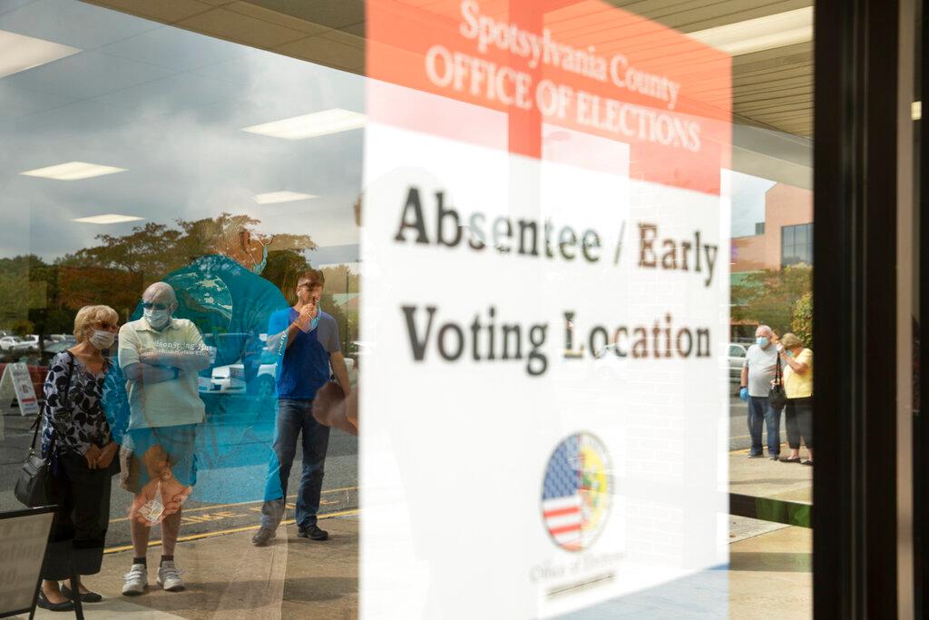 Voters wait in line to cast ballots in the general election