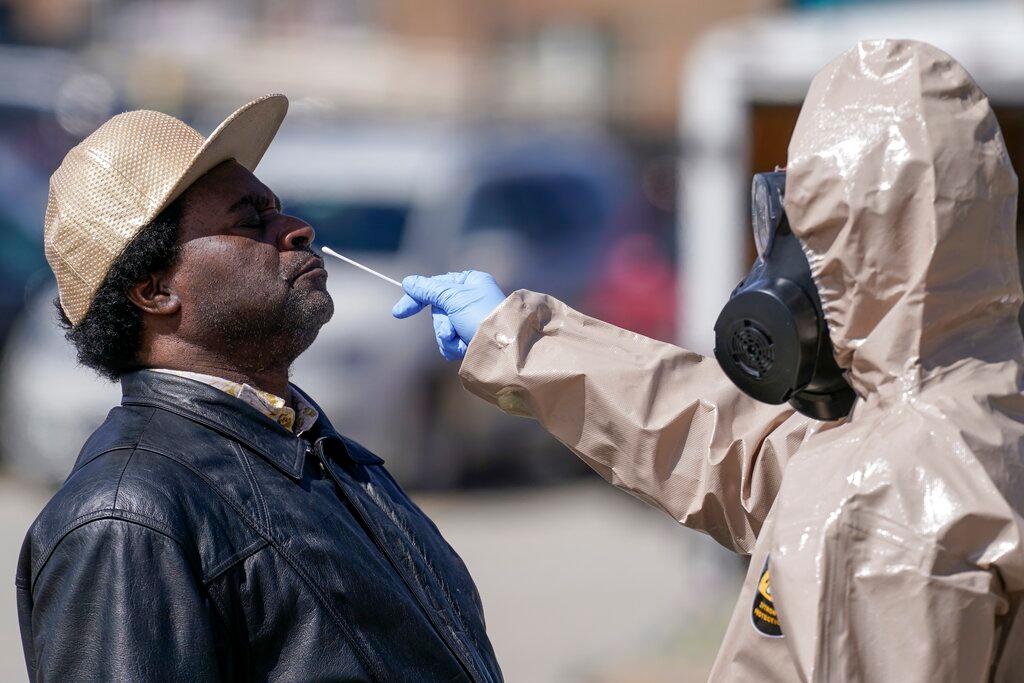 Wisconsin National Guard members administer COVID-19 tests in a parking lot in Milwaukee. 