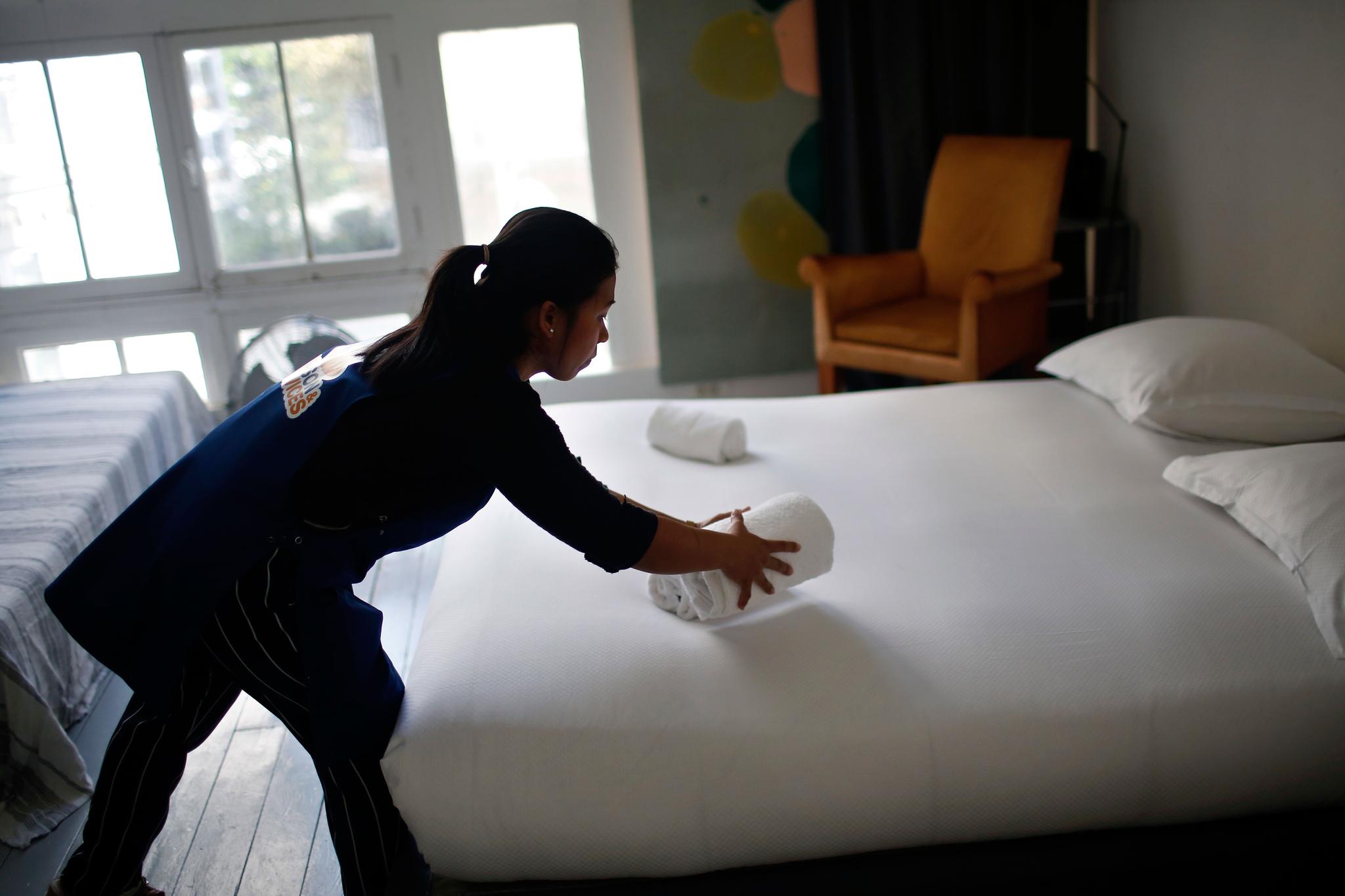 cleaning lady works in an apartment located on Airbnb