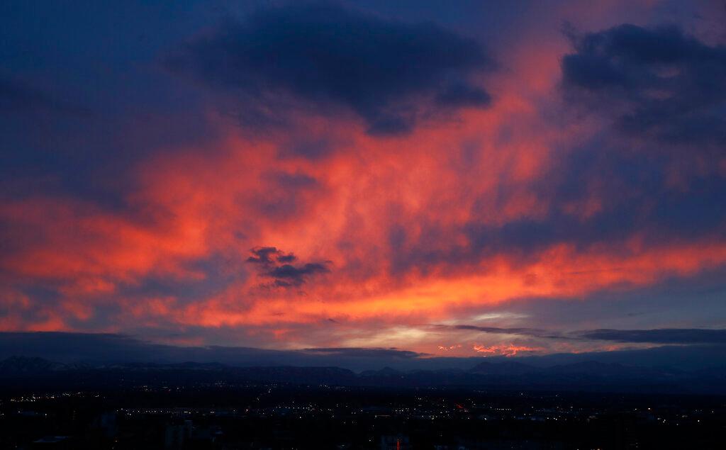 Sun sets behind the Rocky Mountains