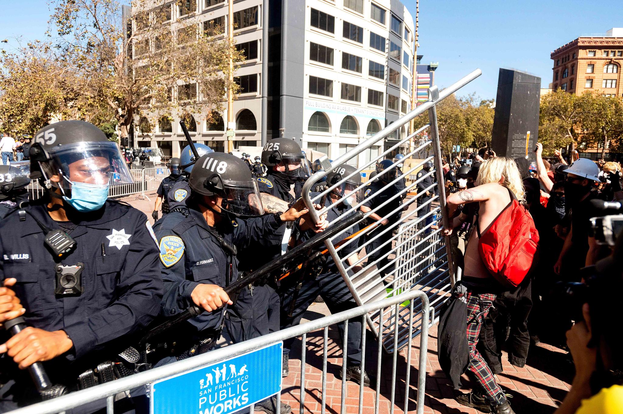 Police officers to to hold off counter-protesters as conservative activists stage a free speech rally in San Francisco on Saturday, Oct. 17, 2020.