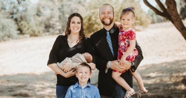 Husband and wife and three children, outside