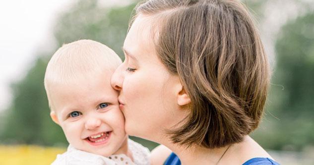 Mom kissing her baby