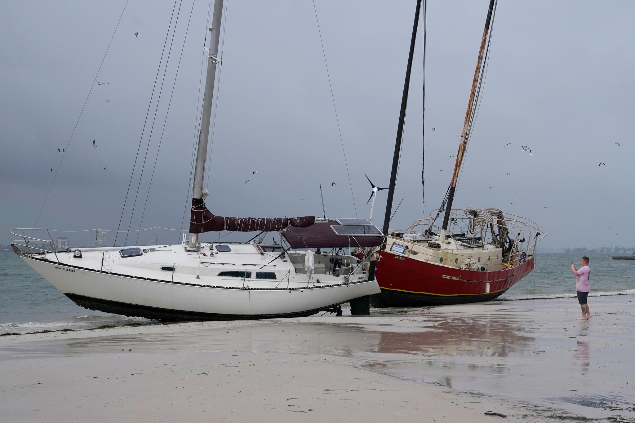 Boats sit on the beach in the aftermath of Tropical Storm Eta