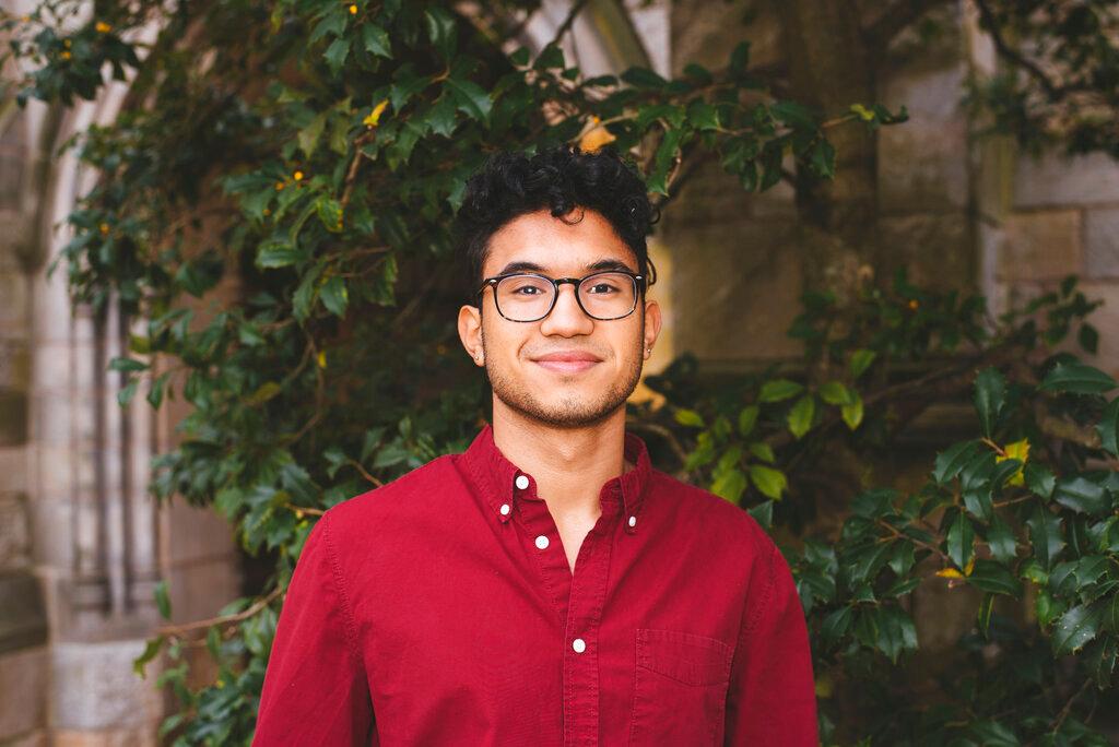 In this Nov. 2019 photo provided by Mila Dorji, Rhodes Scholar Brian Reyes poses for a photo on Yale’s campus in New Haven, Conn. Reyes, a history major at Yale University from the Bronx, is the son of immigrants from the Dominican Republic. He is a student counselor who has been living on campus this school year and taking his classes online. He is planning on a two-year degree program in comparative social policy and a career in government or the nonprofit sector.