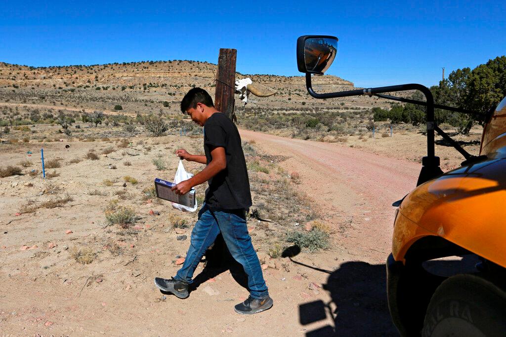 teen with distance learning paperwork