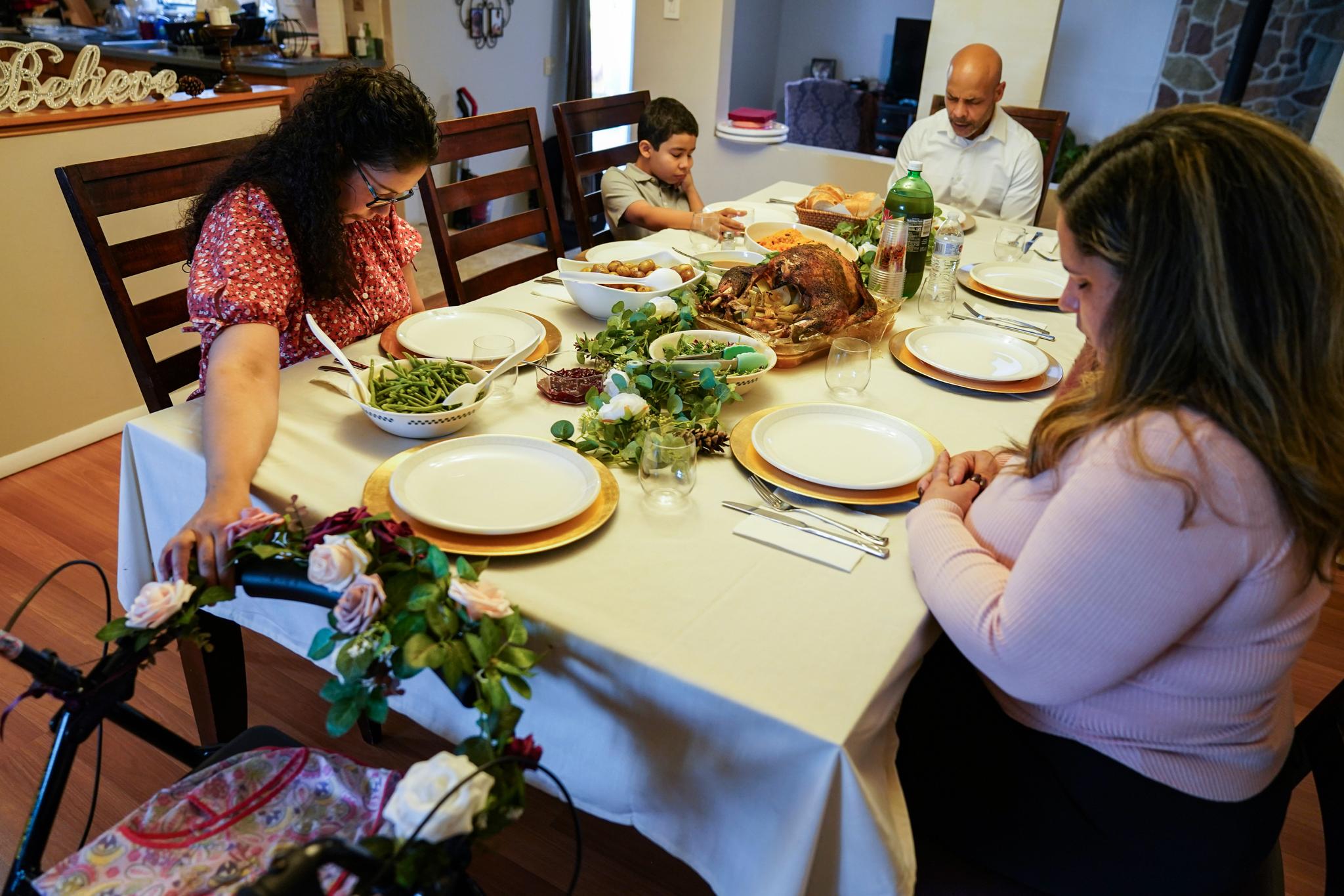 family prayer before holiday meal