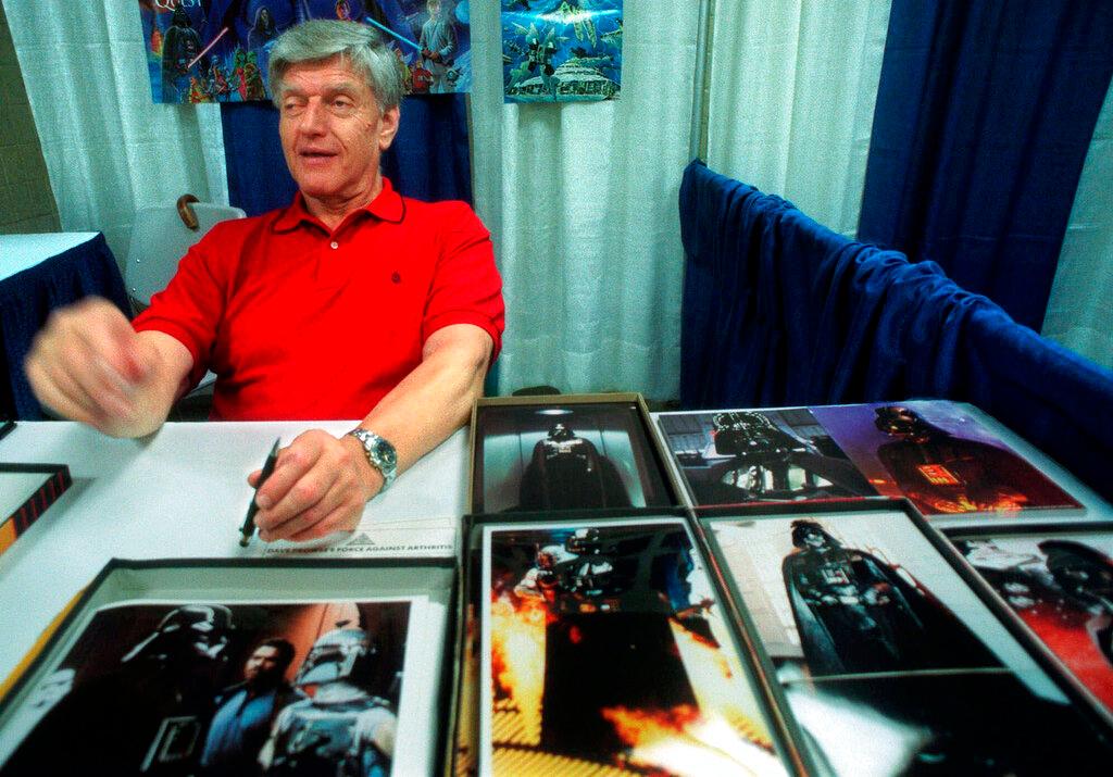 In this file photo dated Friday, May 7, 1999, Dave Prowse, the original Darth Vader from the "Star Wars Trilogy," poses during the New York Comic and Fantasy Creators Convention. The British actor, Prowse who played Darth Vader in the original Star Wars trilogy, has died aged 85 on Saturday, according to an announcement by his agent Sunday Nov. 29, 2020.