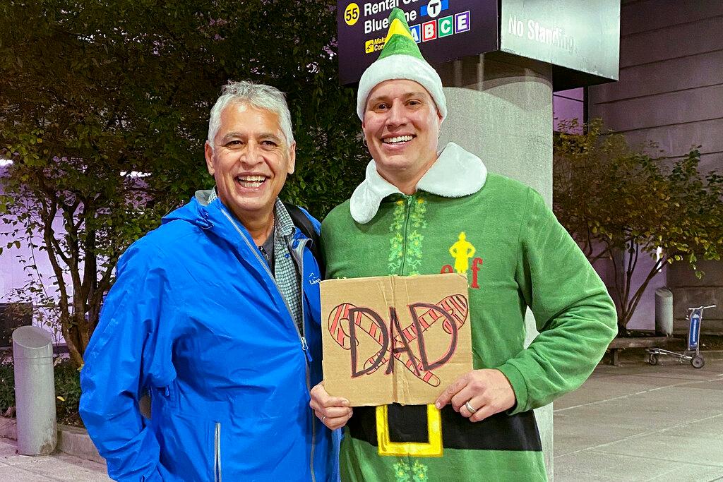 Doug Henning, right, who was adopted as a baby, poses with his biological father after meeting face to face for the first time