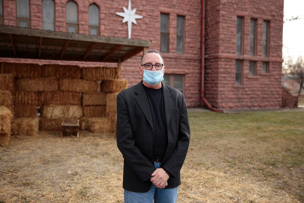 ev. Tim Thies poses in front of the empty Nativity stable at Canton Lutheran Church in Canton, South Dakota on Dec. 8, 2020. The church decided to cancel a live Nativity performance this year after fears a large gathering could lead to more coronavirus deaths in the community.